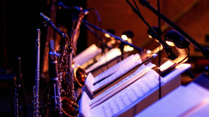 Musical notes and a saxophone under an ambient light