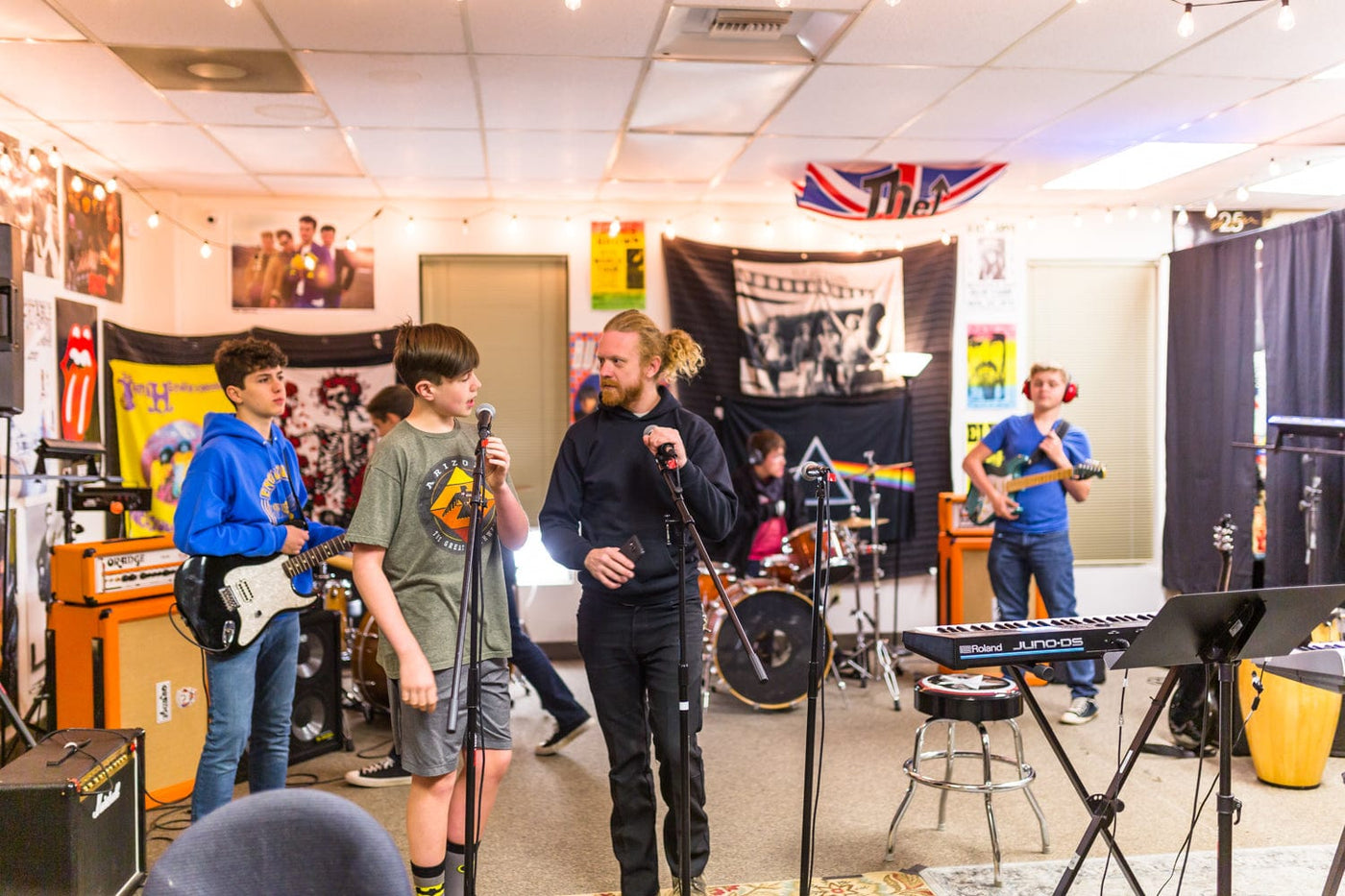 An instructor communicating with a young rocker during their lessons